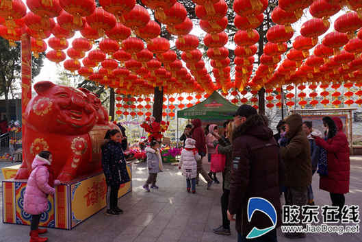 游客們紛紛與本次毓璜頂廟會(huì)的吉祥物“毓福”合影留念